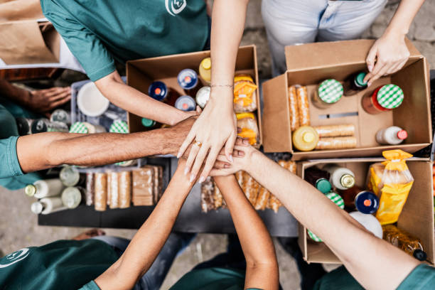 Hands packing donated food